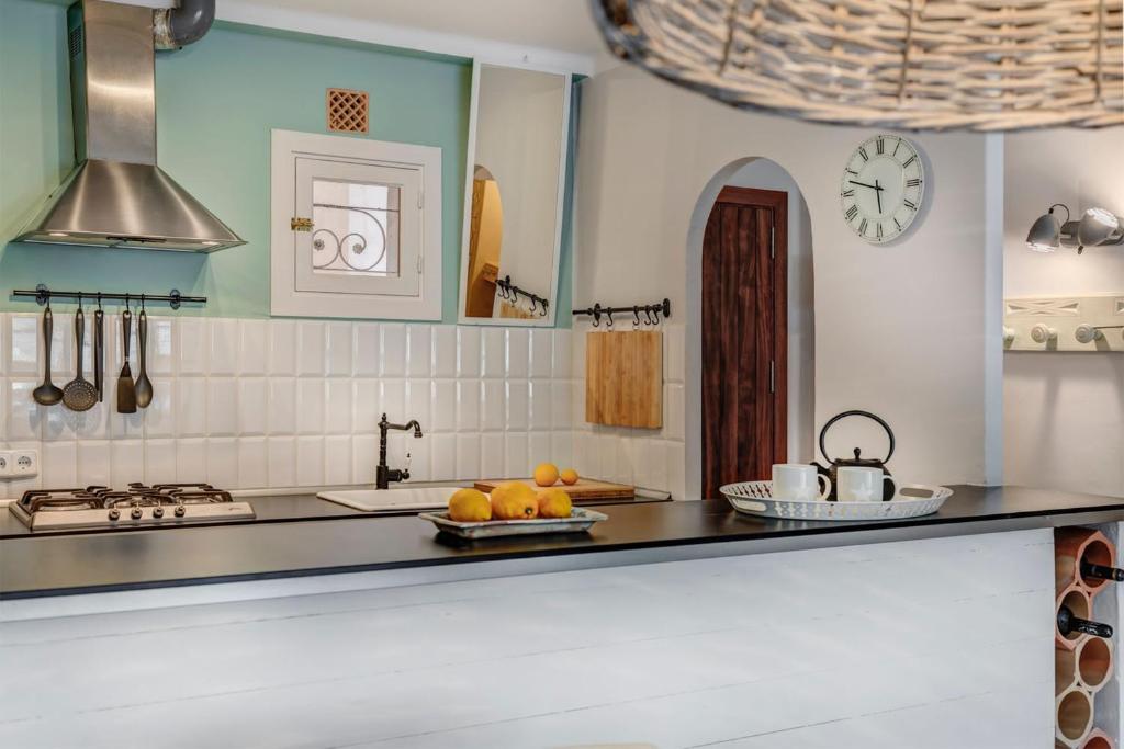 a kitchen with a counter top with fruit on a plate at Beach Apartment Montemar No.1 - perfect ocean view in Sóller