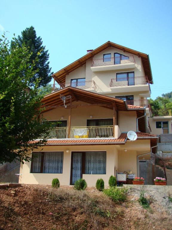an apartment building with balconies on a hill at Villa Shipkovo in Shipkovo