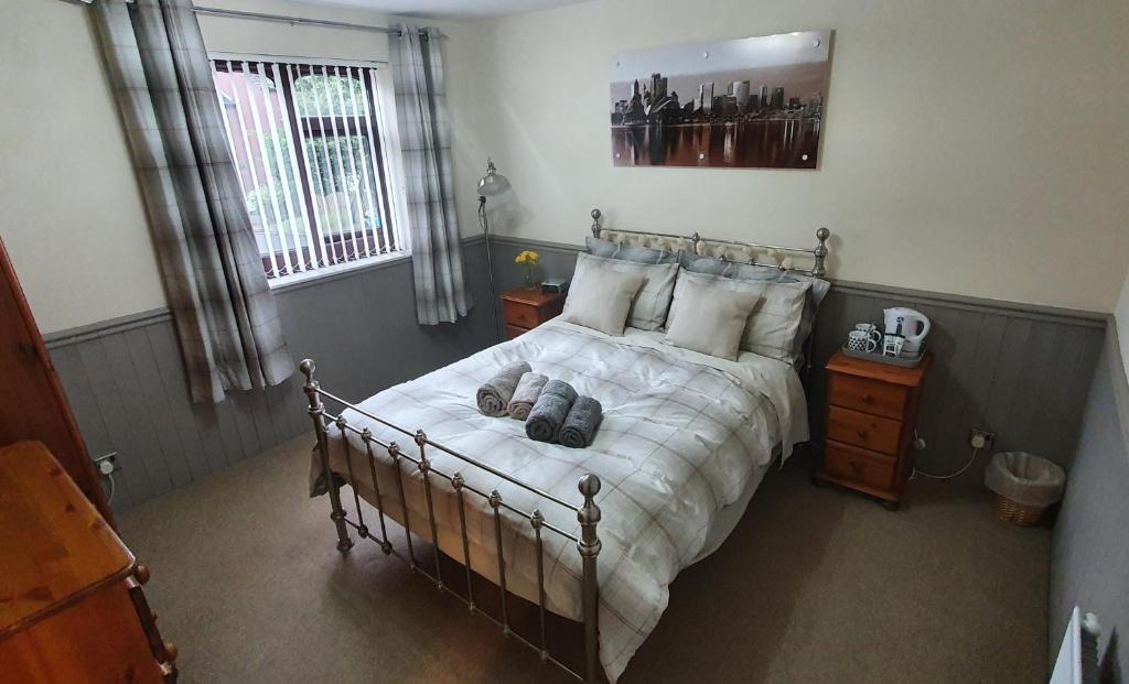 a bedroom with a bed with white blankets and pillows at Double room near Telford Town centre in Telford