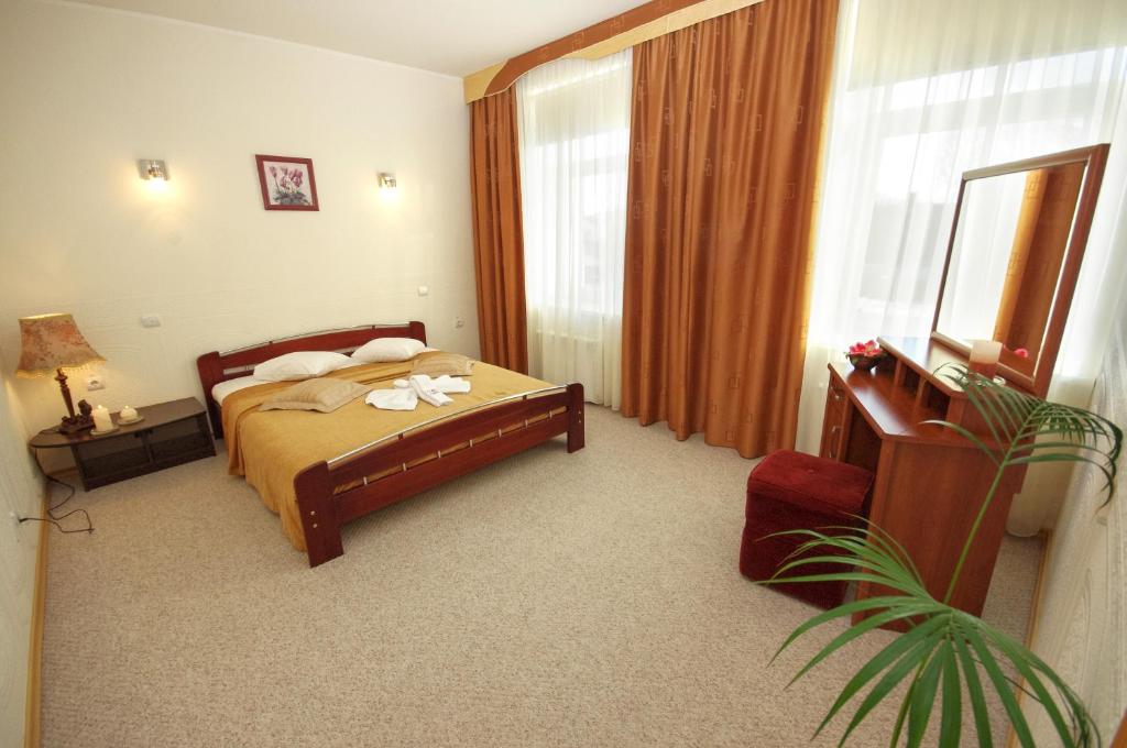 Postel nebo postele na pokoji v ubytování Dinaburg SPA Hotel