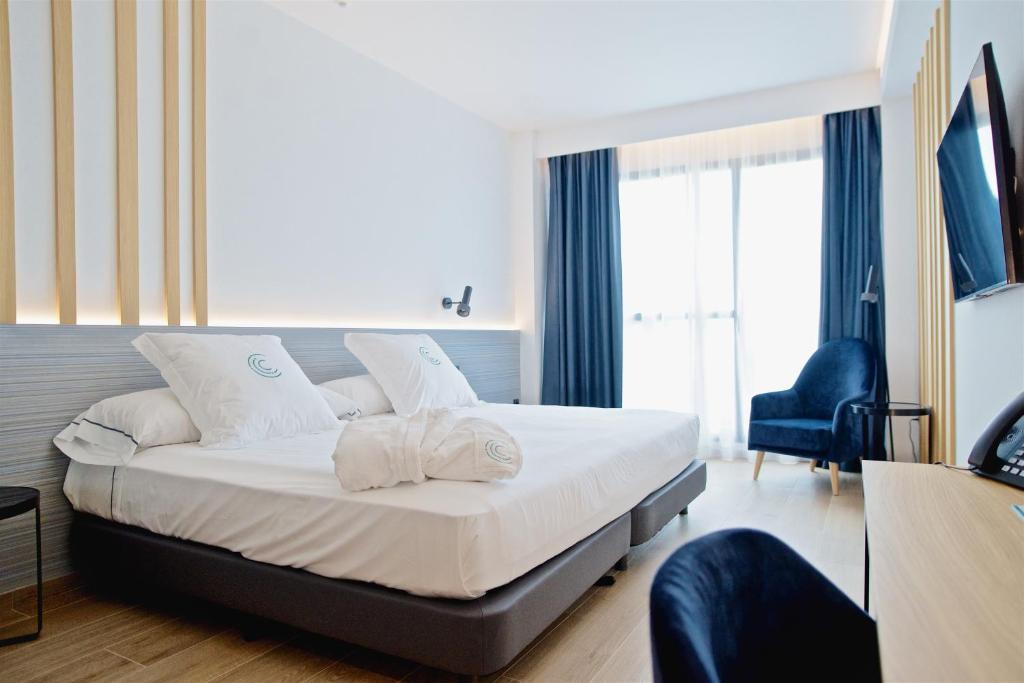 Postel nebo postele na pokoji v ubytování Syncrosfera Fitness & Spa Health Hotel Boutique