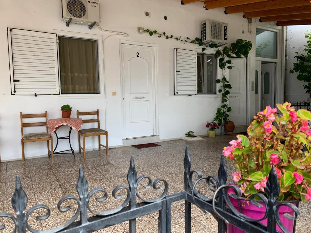 a porch with a fence and a table and chairs at Alexandras Appartments in Igoumenitsa