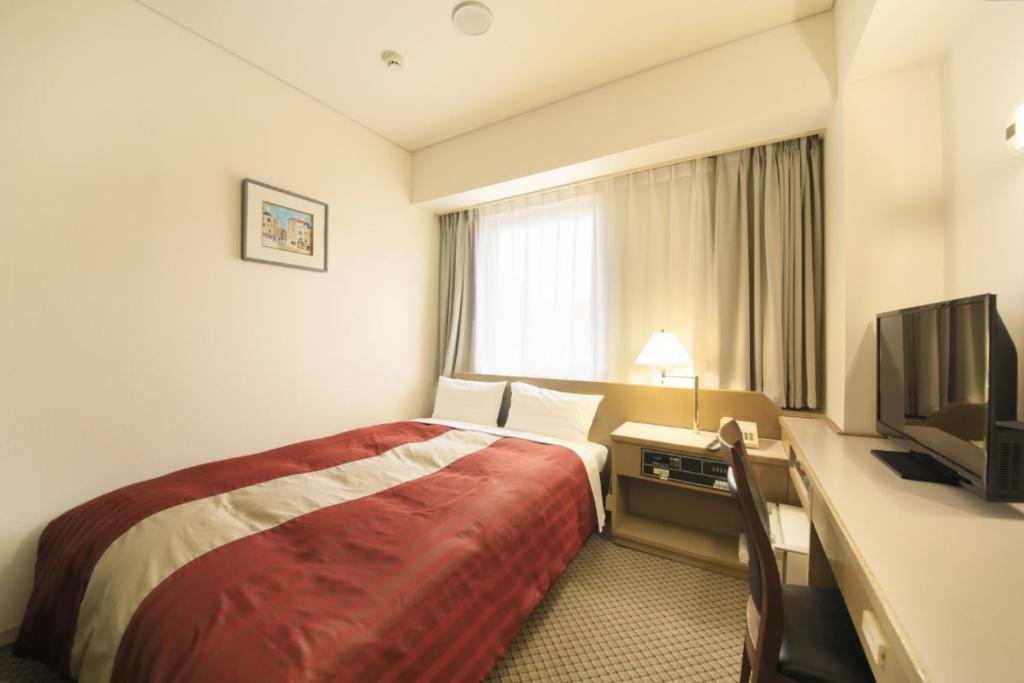 Postel nebo postele na pokoji v ubytování Hotel Nagano Avenue