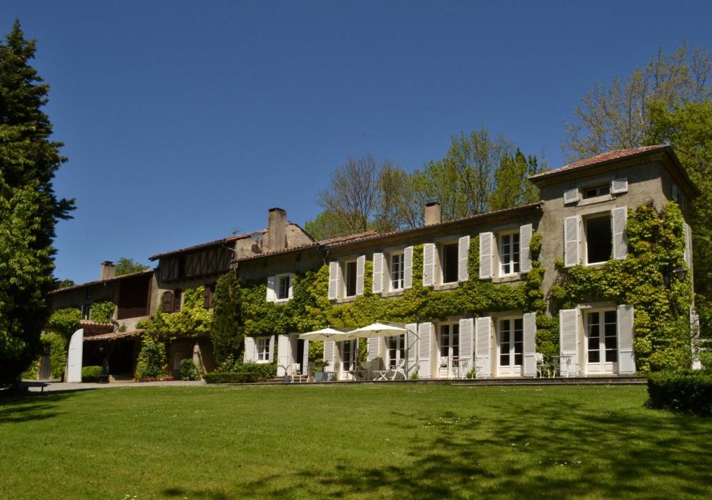 una casa grande con hiedra creciendo en ella en Chambres d'Hôtes Domaine du Hameau Baylesse en Saint-Jean-dʼAigues-Vives