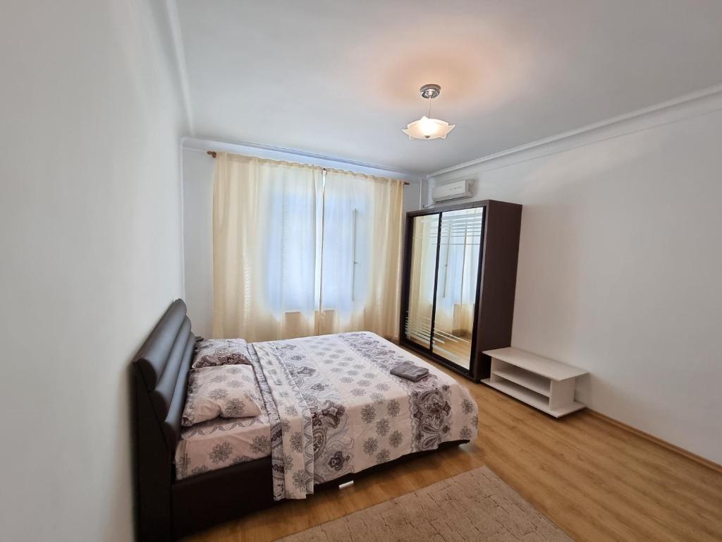 
a bedroom with a bed and a dresser at Stefan cel Mare Lux 2 Rooms apartment centre Chisinau in Chişinău
