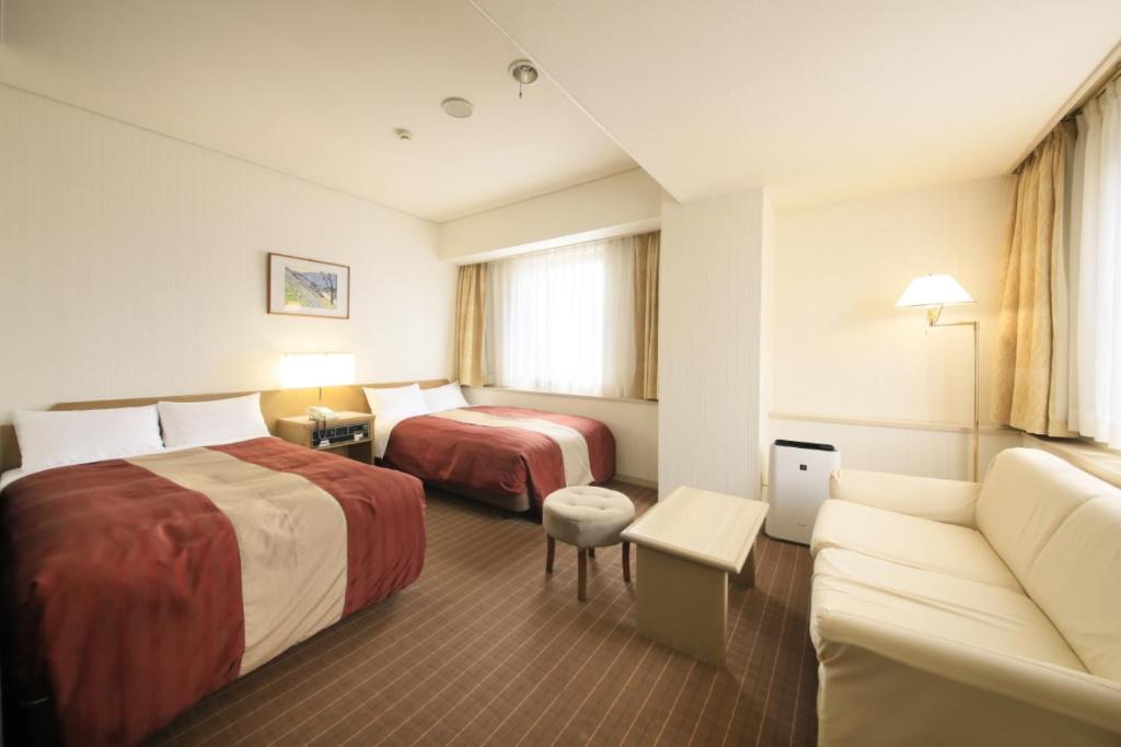 Postel nebo postele na pokoji v ubytování Hotel Nagano Avenue