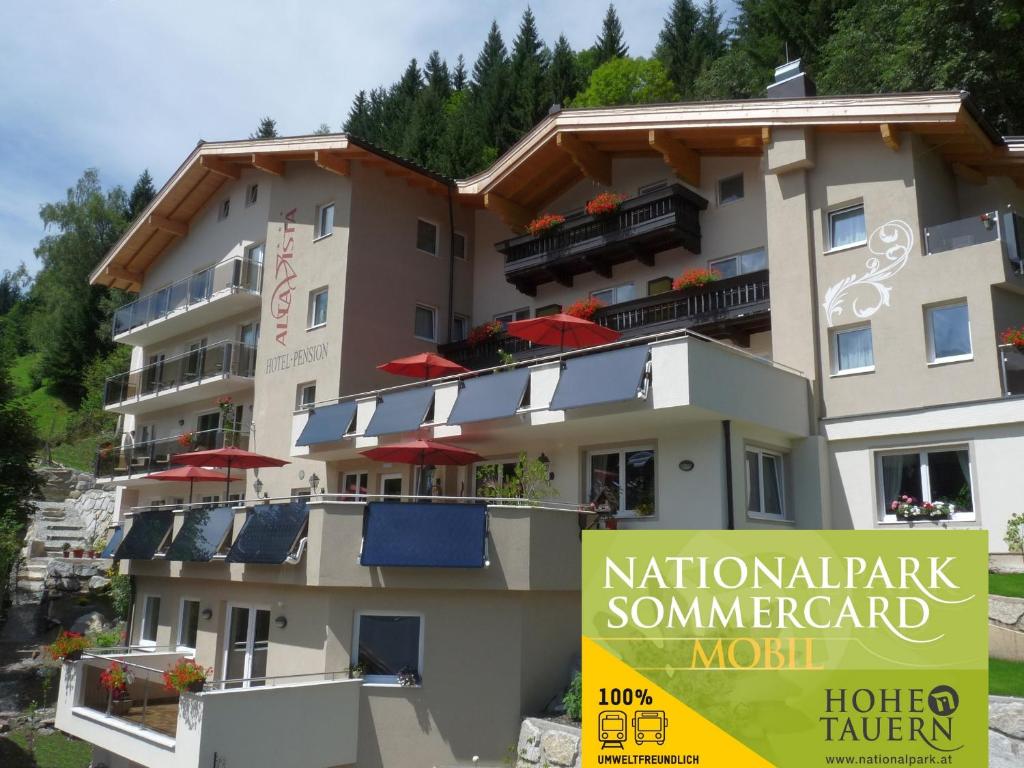 a building with a sign in front of it at Hotel Alta Vista in Neukirchen am Großvenediger