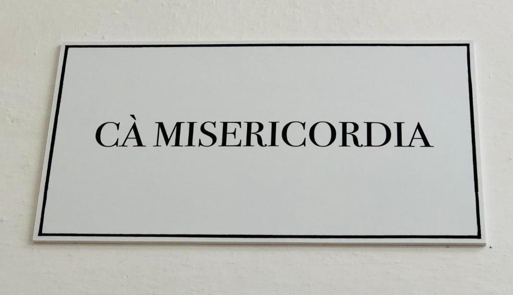 a sign on a wall with the word c mitschota at Cà Misericordia in Venice