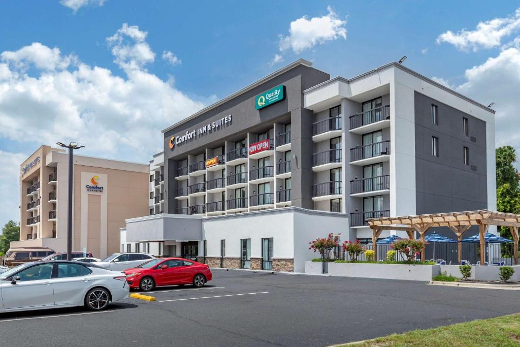 a large building with cars parked in a parking lot at Quality Inn & Suites Spring Lake - Fayetteville Near Fort Liberty in Spring Lake