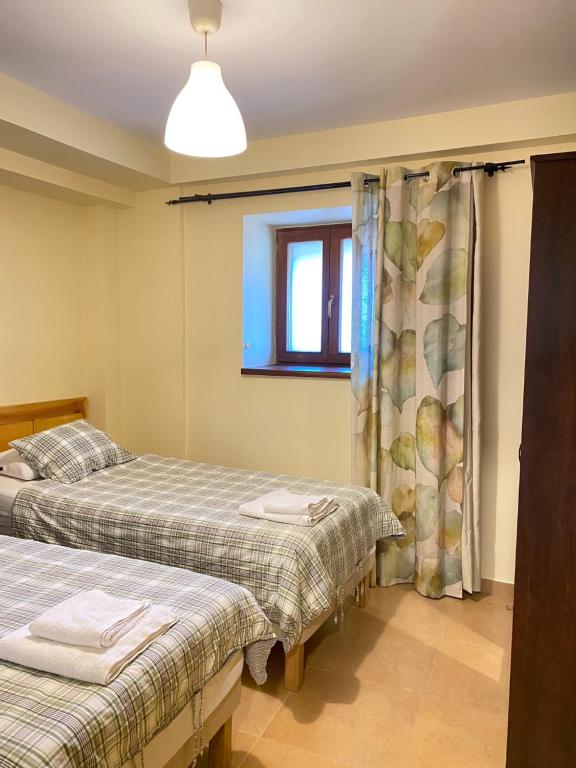 a bedroom with two beds and a window at Apartamentos Playa Galizano in Galizano