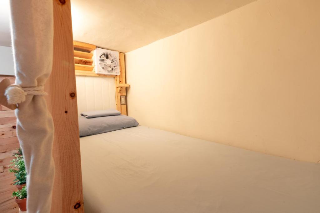 Postel nebo postele na pokoji v ubytování Yilan Inspiration