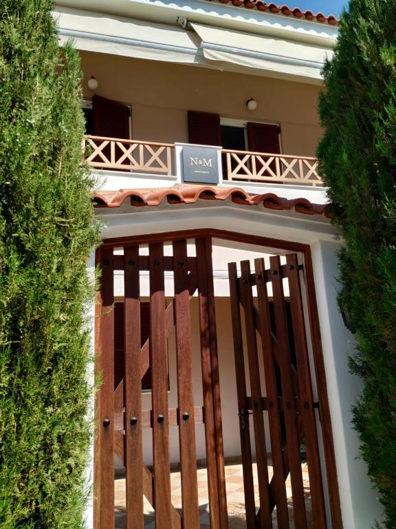 a wooden gate in front of a house at N&Μ in Methana