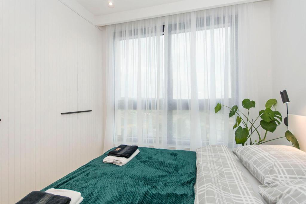 Postel nebo postele na pokoji v ubytování Apartament Rodzinny Portova