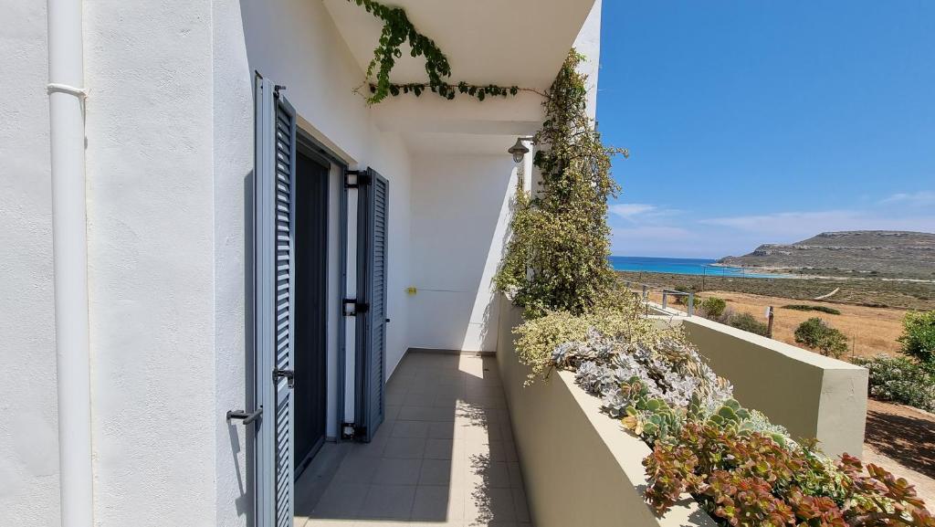 a door to a house with a view of the ocean at Domatia me Thea in Elafonisos