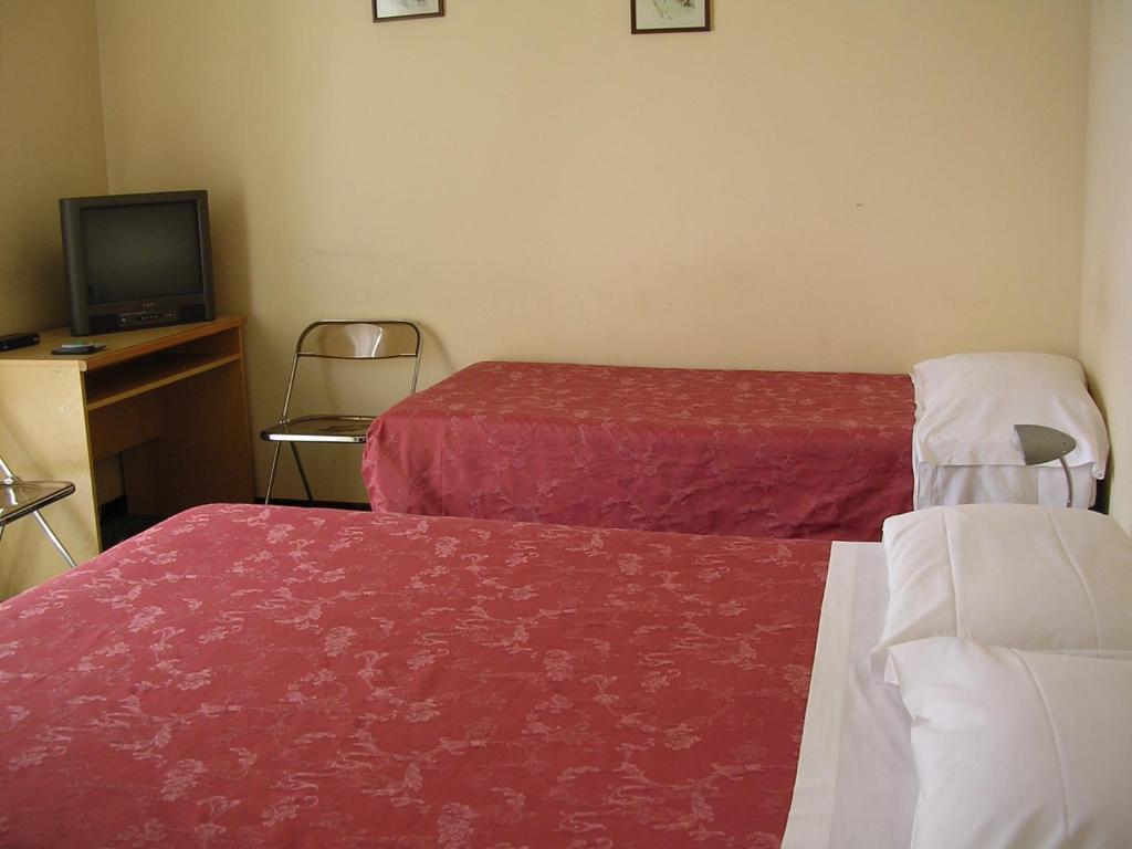 Postel nebo postele na pokoji v ubytování CerrutiHotel