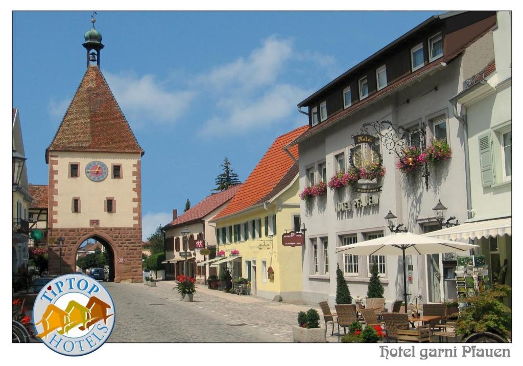 eine Straße in einer Stadt mit einem Uhrturm in der Unterkunft TIPTOP Hotel Garni Pfauen in Endingen