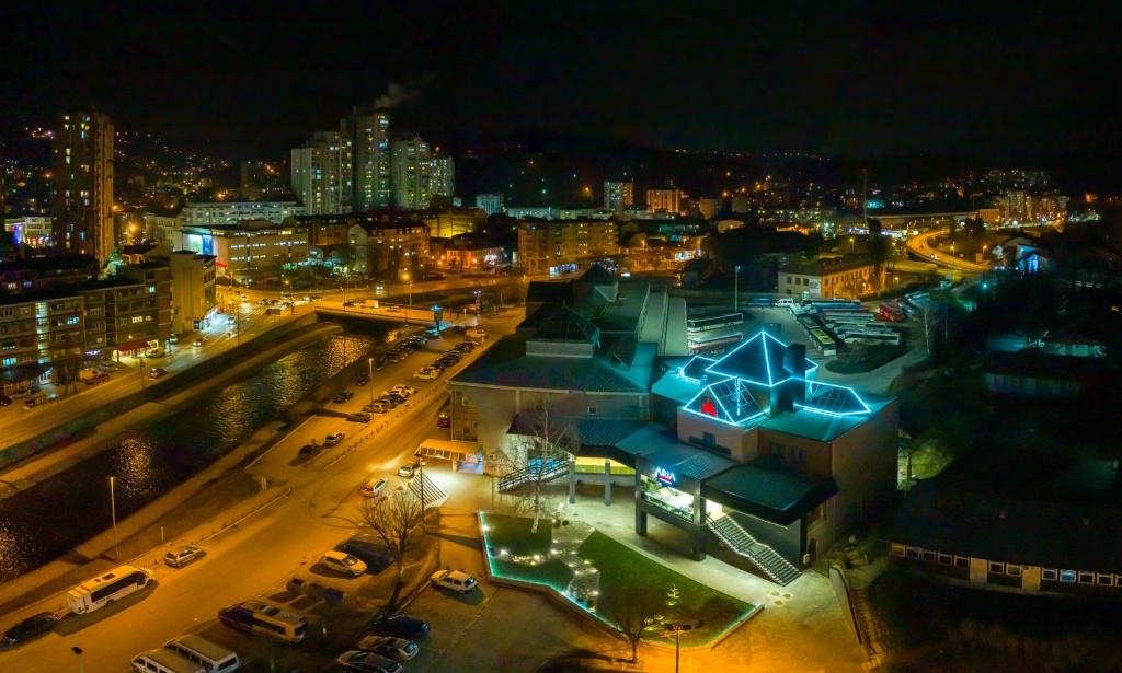a view of a city at night with lights at Hotel Aria in Užice