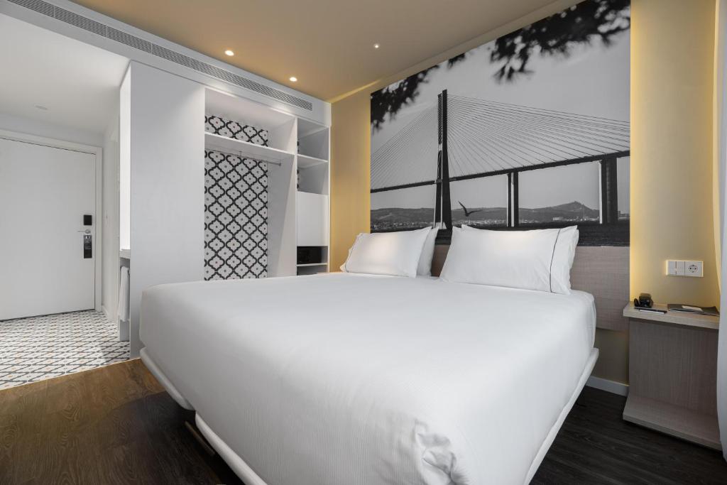 A large bed anchors a modern room with bridge-themed decor.