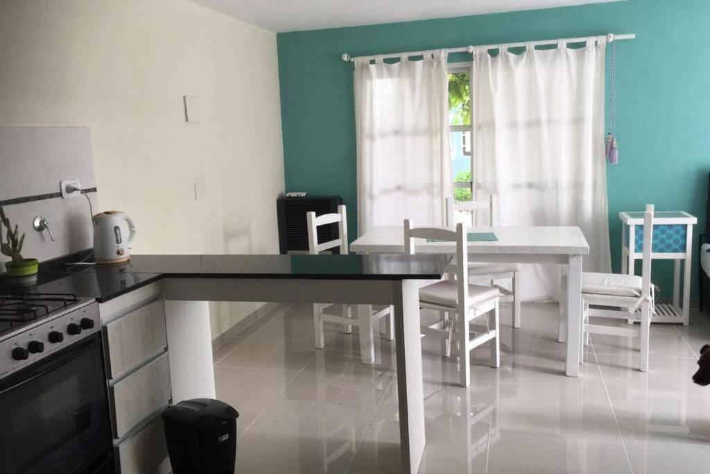 a kitchen with a table and chairs in a room at Departamento frente al mar in Santa Teresita