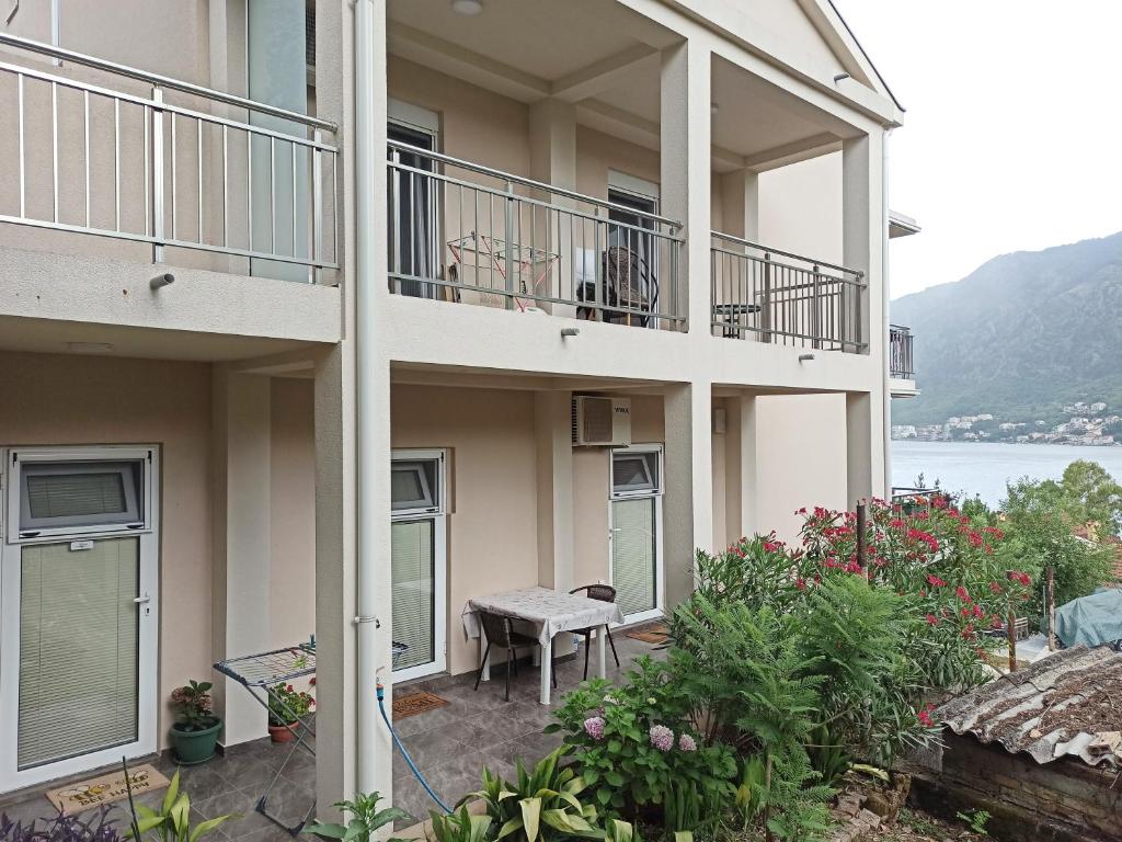 um edifício com uma varanda com um banco em Java apartments - S & J em Dobrota