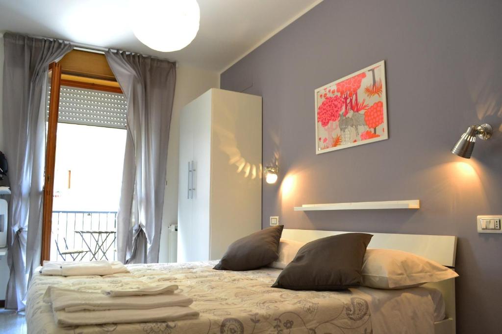 a bedroom with a bed with pillows and a window at Sogni D'Oro - Guest House in Pineto