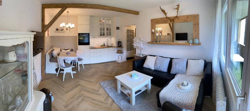 a living room with a couch and a table at Ferienwohnung Rosalie in Inzell