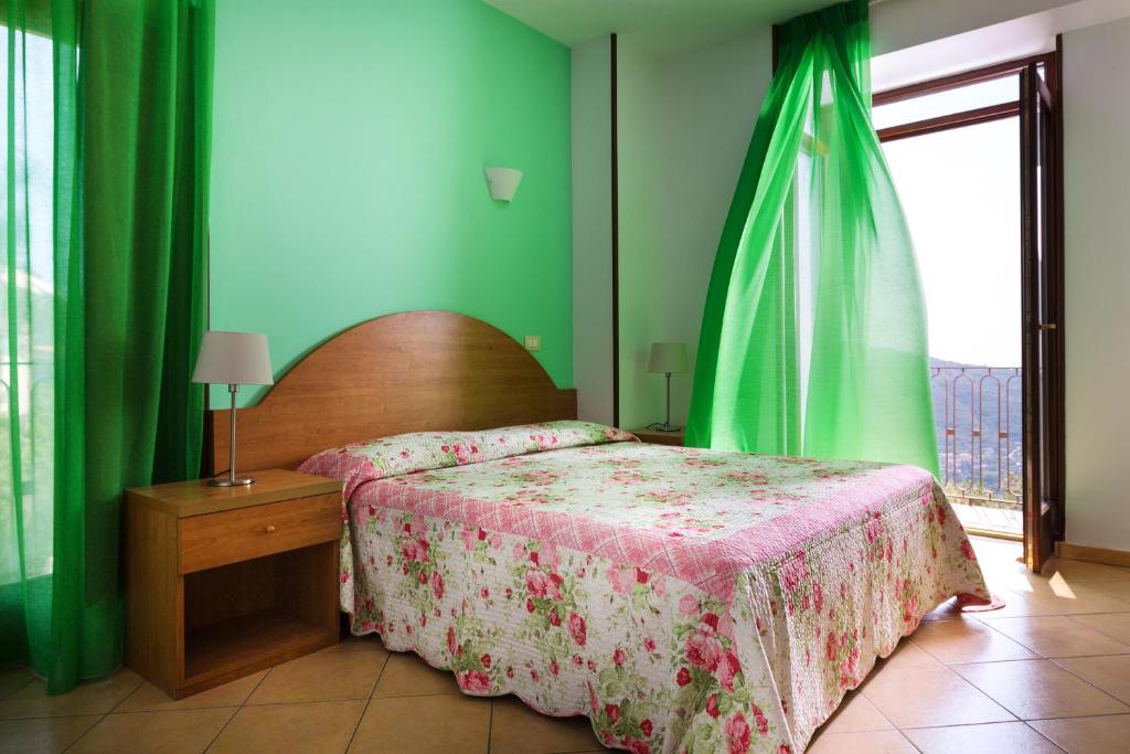 Postel nebo postele na pokoji v ubytování L'Ulivo Resort