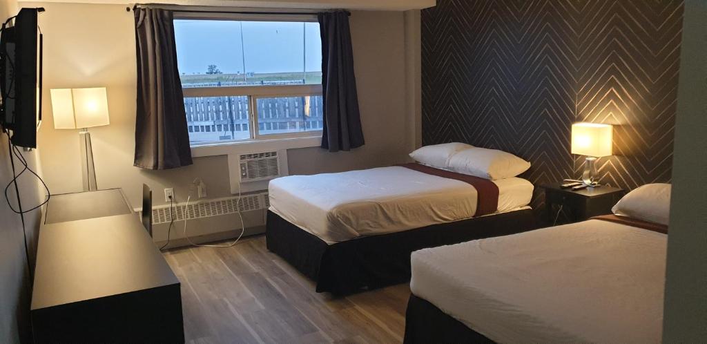 Posteľ alebo postele v izbe v ubytovaní New Frontier Hotel