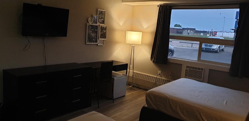 Postel nebo postele na pokoji v ubytování New Frontier Hotel