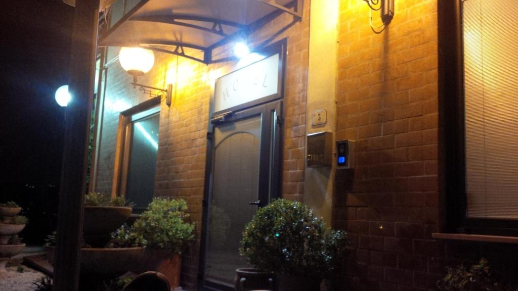 a door to a brick building at night at Albergo Ristorante La Greppia in Montedivalli Chiesa