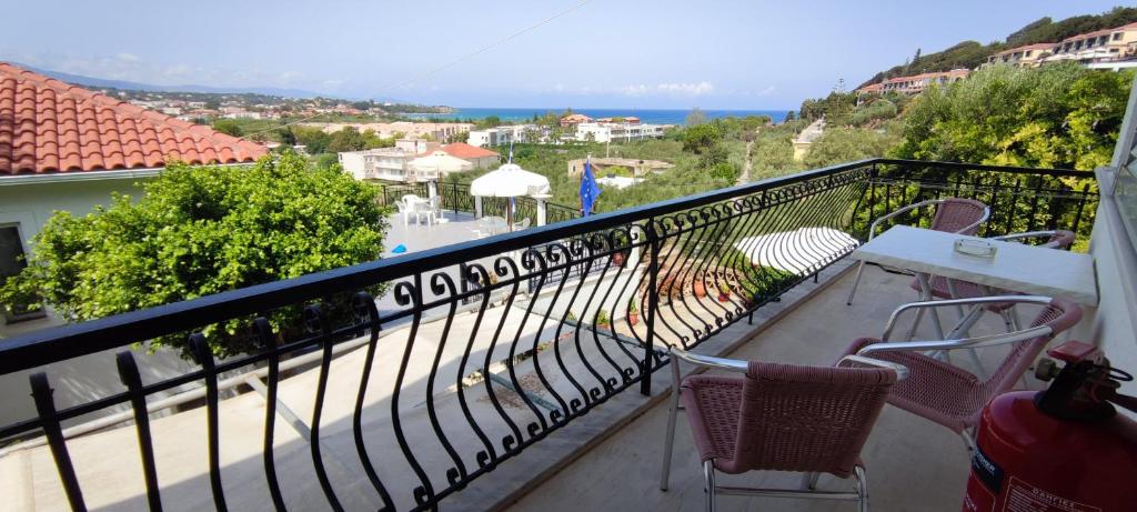 a balcony with chairs and a view of the ocean at Anna Studio and Apartments in Tsilivi