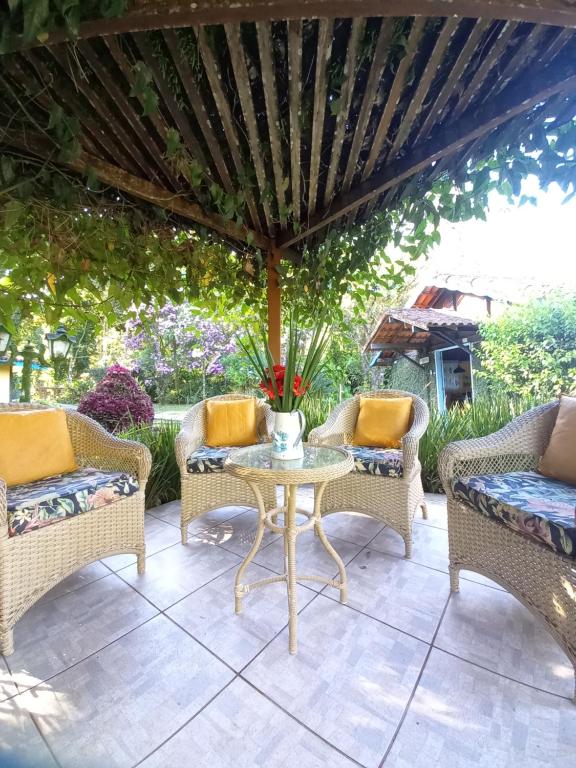 a patio with wicker chairs and a table at Repousada Sana in Sana