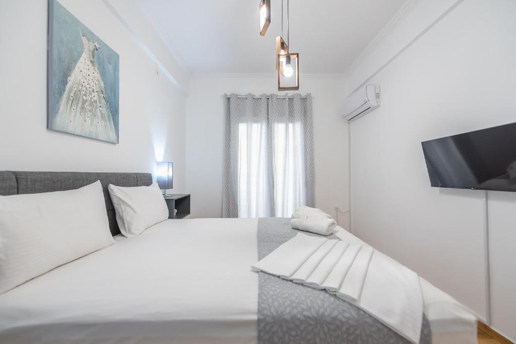 A bed or beds in a room at Athens Bright Suite by CloudKeys
