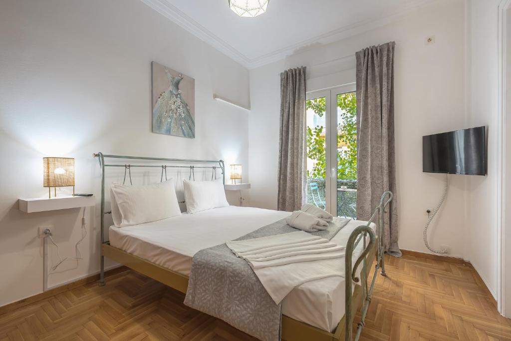 A bed or beds in a room at Athens Bright Suite by CloudKeys