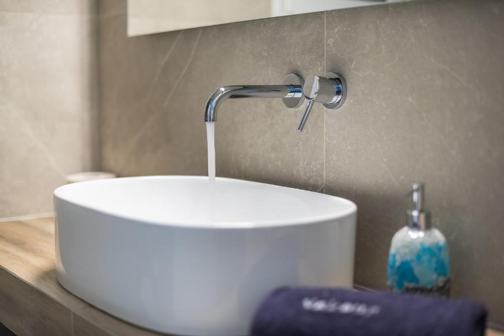 A bathroom at Athens Bright Suite by CloudKeys
