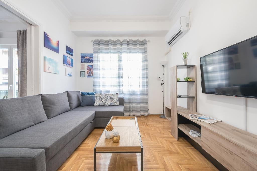A television and/or entertainment centre at Athens Bright Suite by CloudKeys