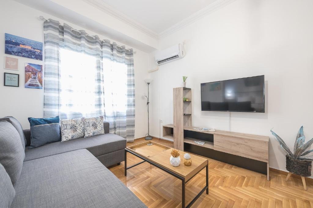 A television and/or entertainment centre at Athens Bright Suite by CloudKeys
