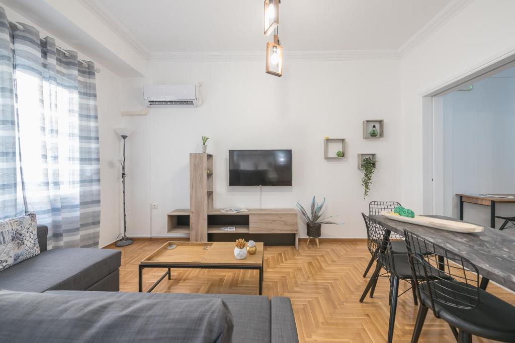 A television and/or entertainment centre at Athens Bright Suite by CloudKeys