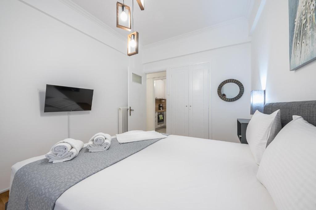 A bed or beds in a room at Athens Bright Suite by CloudKeys
