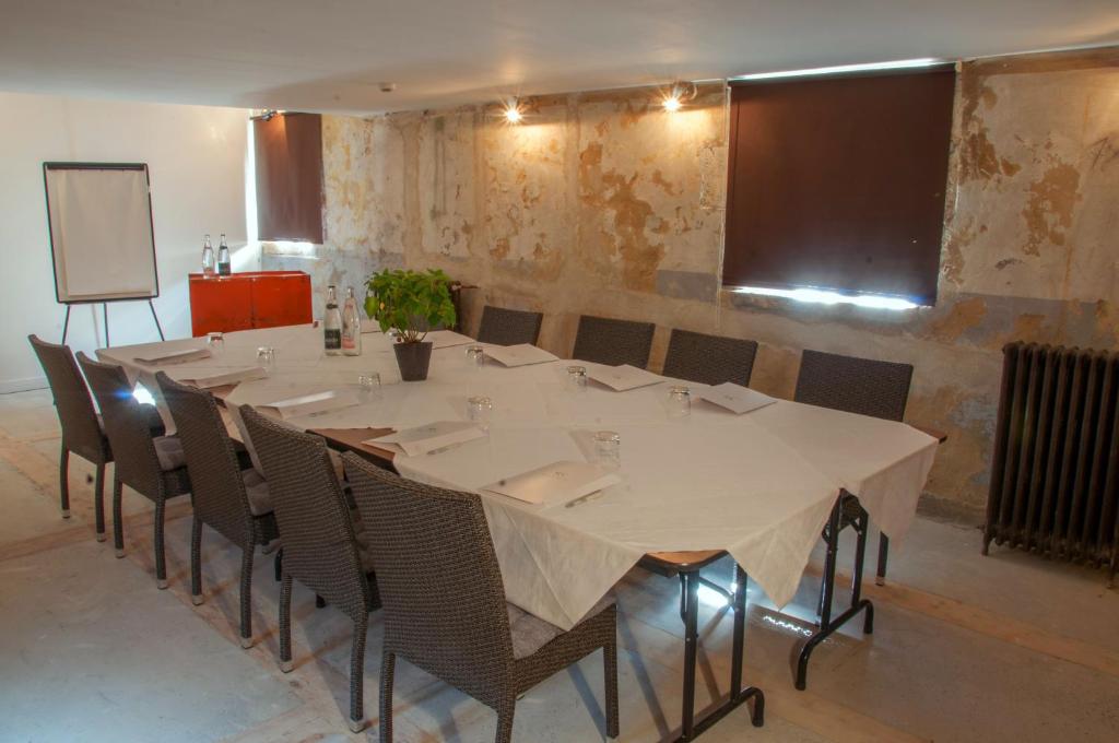 a conference room with a large table and chairs at Domaine du Châtelard in Dirac