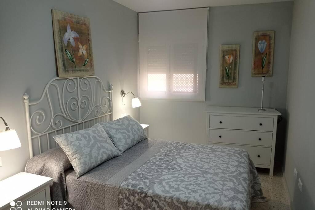 een slaapkamer met een bed en een dressoir bij Apartamento cabañiles wifi in Jerez de la Frontera