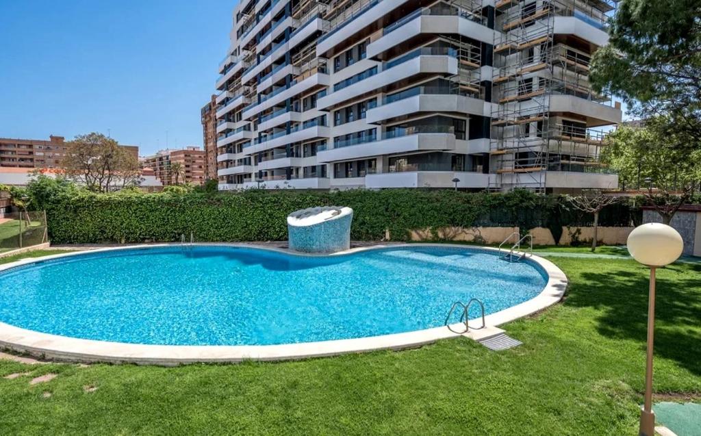 a swimming pool in front of a apartment building at Palau de Vic in Valencia