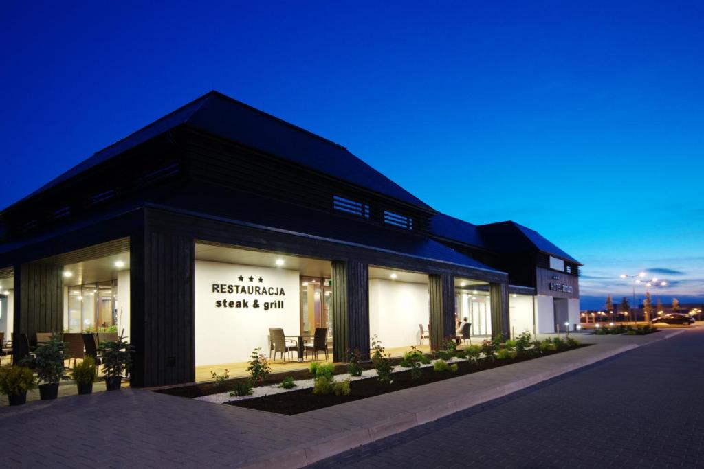 a black building with a sign in the window at Hotel Antonio Conference in Brzeg