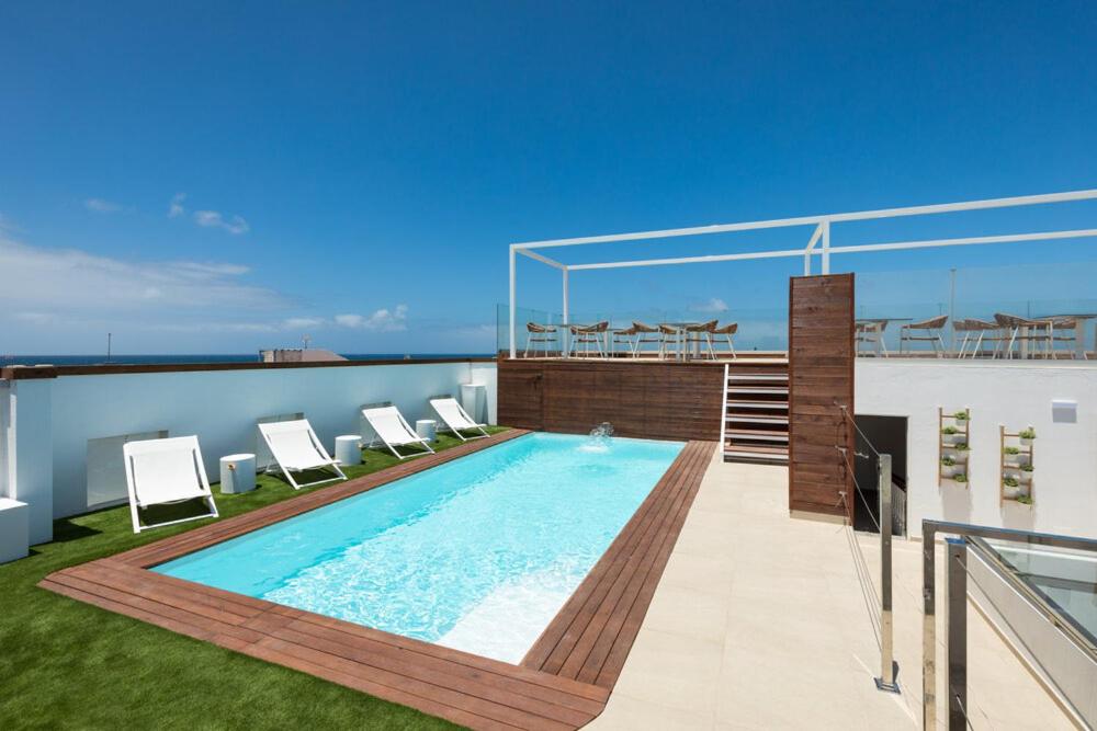 a swimming pool on the roof of a building at Cotillo House in El Cotillo