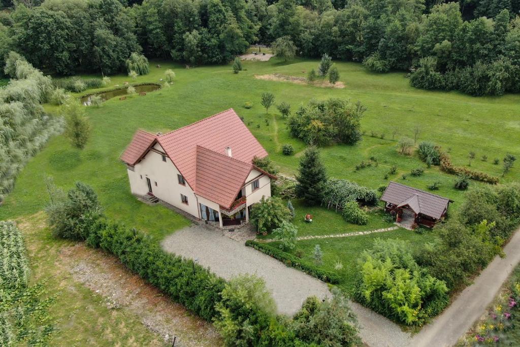 an aerial view of a house with a red roof at Pensiunea Mara in Deseşti