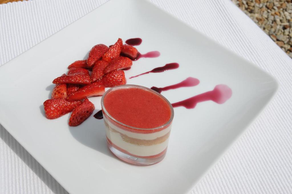 a dessert with strawberries on a white plate at Domaine du Châtelard in Dirac