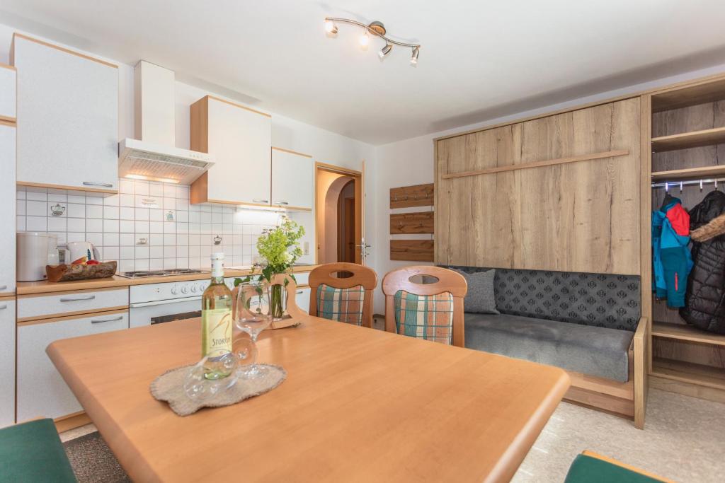 a kitchen with a wooden table in a kitchen at Haus Schwaighofer in Saalbach-Hinterglemm