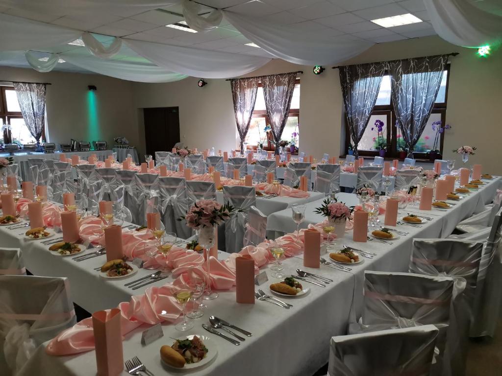 a banquet hall with white tables with food on them at Penzión** Amálka in Hriňová