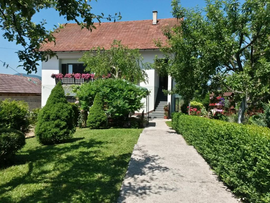 a house with a garden and a walkway at Guesthouse Pavličić in Drežnik Grad