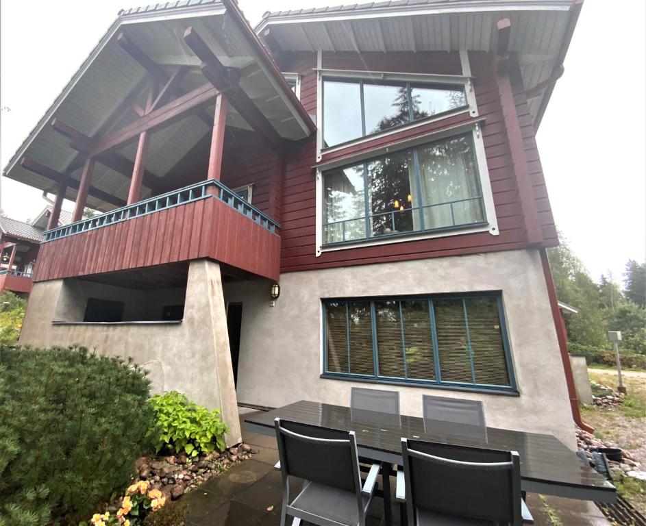 a house with a table and chairs in front of it at Villa Sea Golf Rönnäs in Loviisa